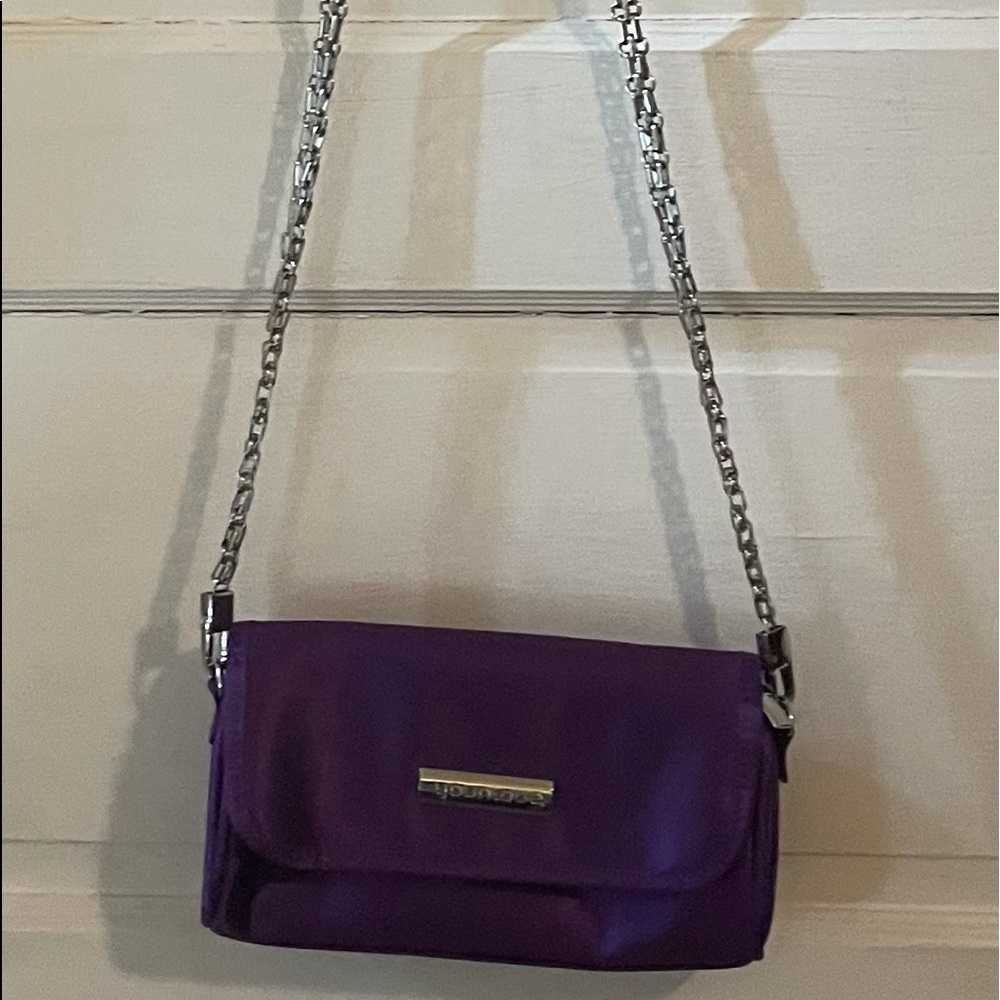 Purple clutch with silver colored removable strap